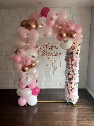 Pink and white birthday arch