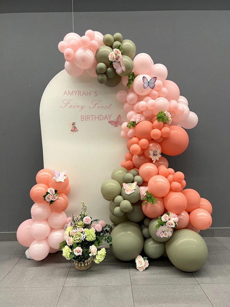 Birthday and party decor setup with balloons and florals